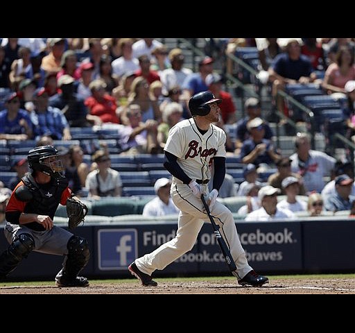 Atlanta Braves' B.J. Upton, right, celebrates with Freddie Freeman after  scoring on a single hit by Andrelton Simmons during the third inning of a  baseball game against the Chicago Cubs in Chicago