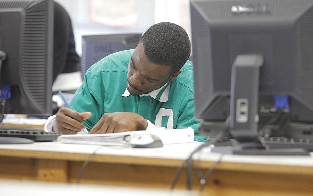 Jumoke Johnson works on a college application in the library of Brainerd High School on Monday, April 16, 2012. 