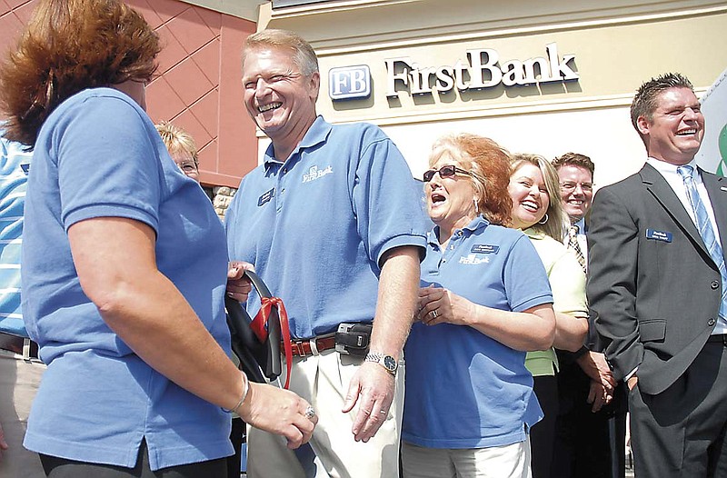 Staff Photo by Tim Barber
Sam Jones, city president of FirstBank, stands with fellow bank employee's at the opening of the Hamilton Place Blvd. branch on Friday. The financial institution is located at 2021 Hamilton Place Blvd.