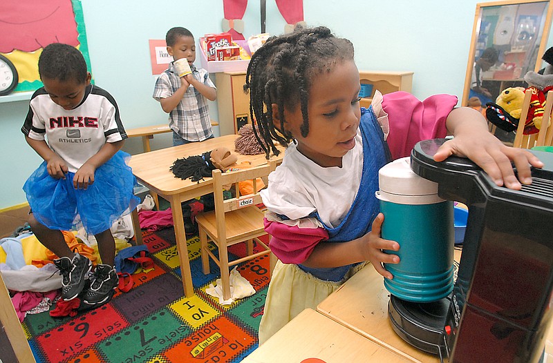 Staff Photo by Allison Kwesell
Asziauna Berry, 4, right, pretends to make coffee at Human Services Childcare. The Chattanooga Human Services Program has earned its accreditation from the National Association for the Education of Young Children, the nation's leading organization of early childhood professionals.