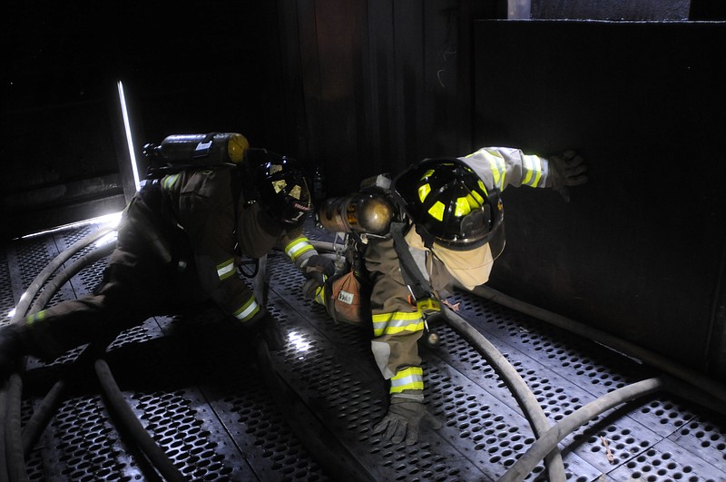 Staff File Photo: Walker County State Prison firefighter Jeffery Wade, right, and Fort Oglethorpe firefighter J.T. Colom perform a search-and-rescue task while taking their state qualification test at Walker County Fire Station 6.