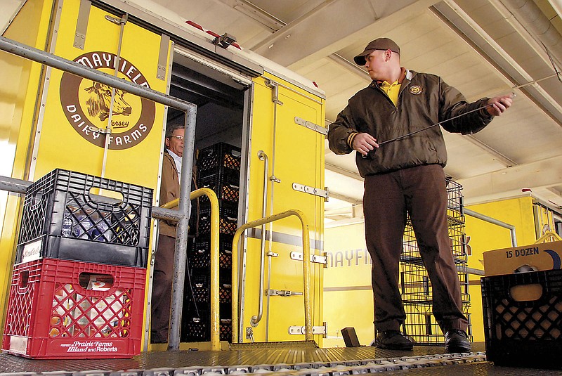 Staff photo by Danielle Moore/Chattanooga Times Free Press
David Gray, right, and Tommy Blevins load milk crates onto a truck at the Mayfield Dairy distribution center on Polymer Drive in Chattanooga. Mayfield Dairy will turn 100 this year.