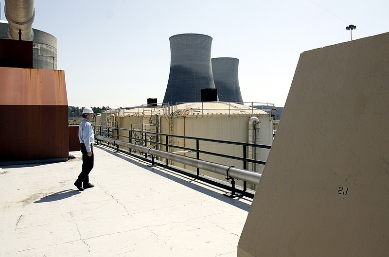Terry Johnson walks toward the TVA Sequoyah Nuclear Power Plant's cooling towers in Soddy-Daisy.