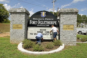 Staff photo by John Rawlston/Chattanooga Times Free Press - Aug 18, 2010
Fort Oglethorpe city employees Tony Holland, left, and Phil Morton put a message honoring Mayor Ronnie Cobb on the city's sign at the intersection of LaFayette Road and Highway 2A on Wednesday afternoon. The Fort Oglethorpe mayor passed away on Tuesday.