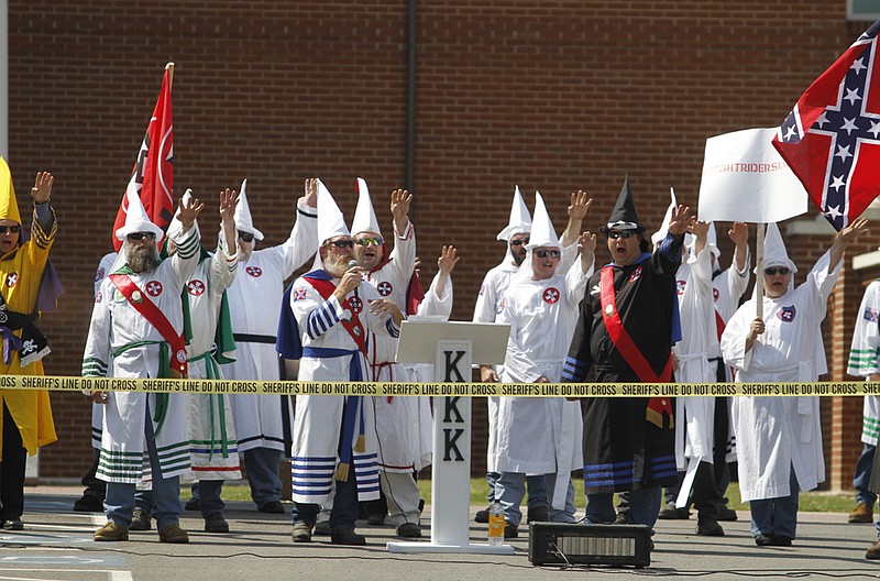Staff photo by Jake Daniels/Chattanooga Times Free Press -- Sep 11, 2010
Brother Jeff Jones, center, with microphone, and other members of the Ku Klux Klan salute and shout "white power" during their rally on Saturday.
