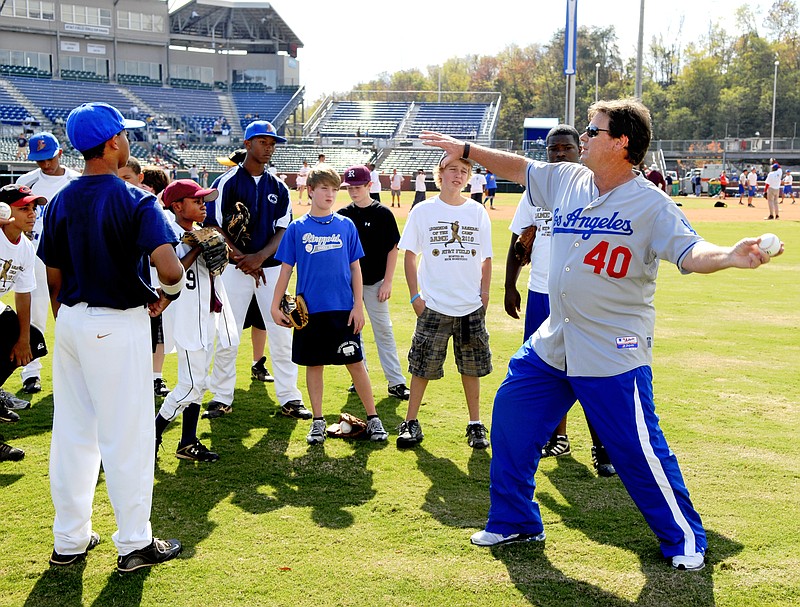 Los Angeles Dodgers pitching coach Rick Honeycutt talks about throwing with participants in the Legends of the Game baseball camp at AT&T Field in 2010.