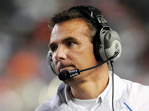 In this Oct. 16, 2010, file photo, Florida's Urban Meyer looks on during the first half against Mississippi Sate in an NCAA college football game in Gainesville, Fla. Meyer is stepping down as coach after the Gators appearance in the Outback Bowl. In a statement released by the university on Wednesday, Dec. 8, 2010, Meyer says "it is time to put my focus on my family and life away from the field." (AP Photo/Phil Sandlin, File)