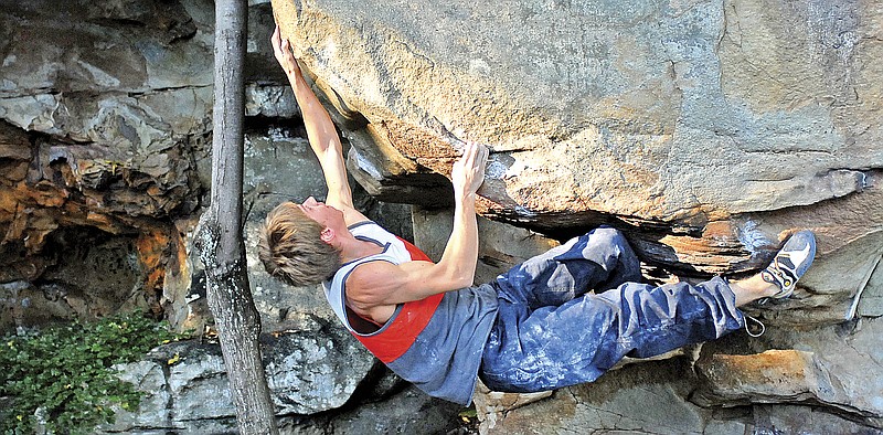 Brad Weaver climbs a boulder at Little Rock City on the Montlake Golf Course property in Soddy-Daisy. Staff File Photo