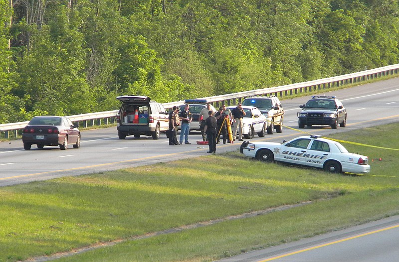 Investigators search for clues in the median of I-75 after Armetta Foster was shot and killed by a deputy in 2011. 
Staff photo by Randall Higgins