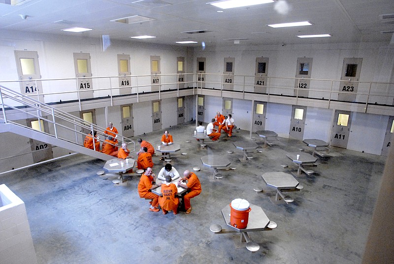 Prisoners sit in the common area of one of the cell blocks in the new Bledsoe County Detention Center in Pikeville, Tenn.