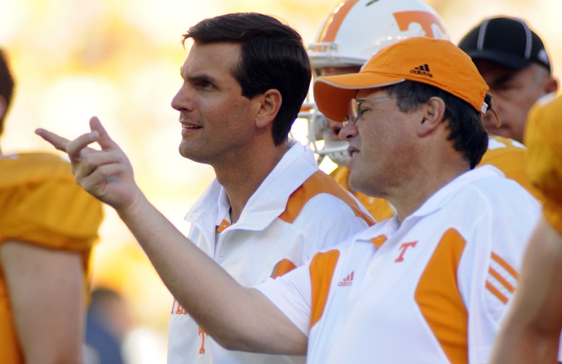 In this file photo, UT offensive coordinator Jim Chaney, right, talks with head coach Derek Dooley during practice before a game against UT Martin at Neyland Stadium.