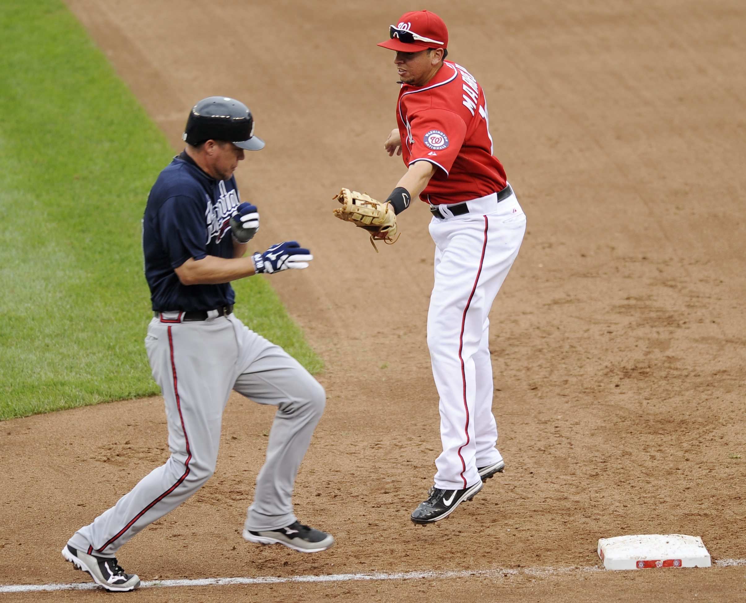 Atlanta Braves' Eli Marrero, center, Chipper Jones, left, and