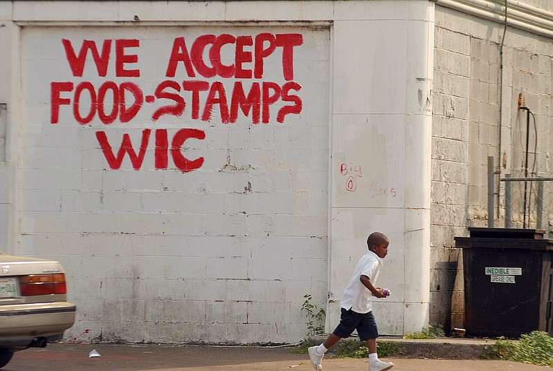 The Nine Brothers convenience store on 38th Street in Alton Park has a large hand-painted sign announcing that they accept food stamps and WIC vouchers in this 2007 file photo.