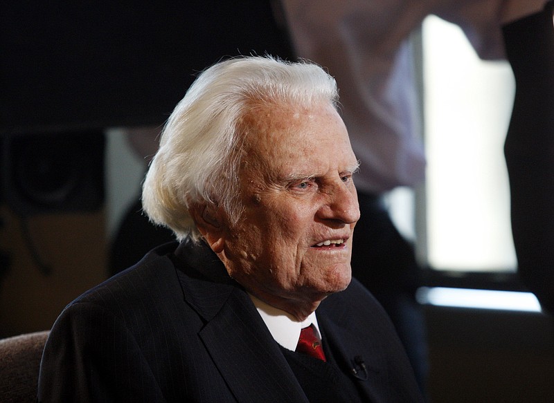 In this Dec. 20, 2010 file photo, evangelist Billy Graham, 92, is interviewed at the Billy Graham Evangelistic Association headquarters in Charlotte, N.C.  (AP Photo/Nell Redmond, File)