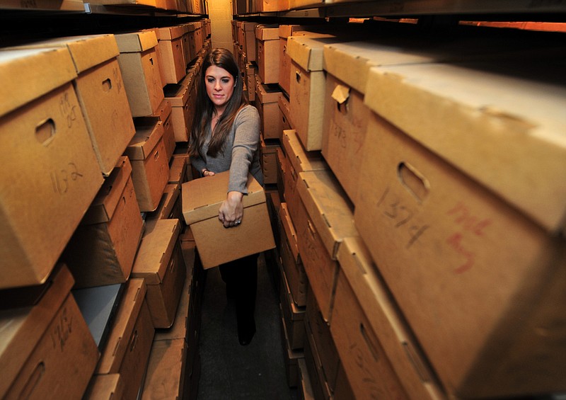 Archival assistant Kimberly Wires pulls one of the estimated 10,000 boxes of unarchived Tennessee Supreme Court documents from 1827-1950 that are being catalogued and examined at the State Library and Archives in Nashville.