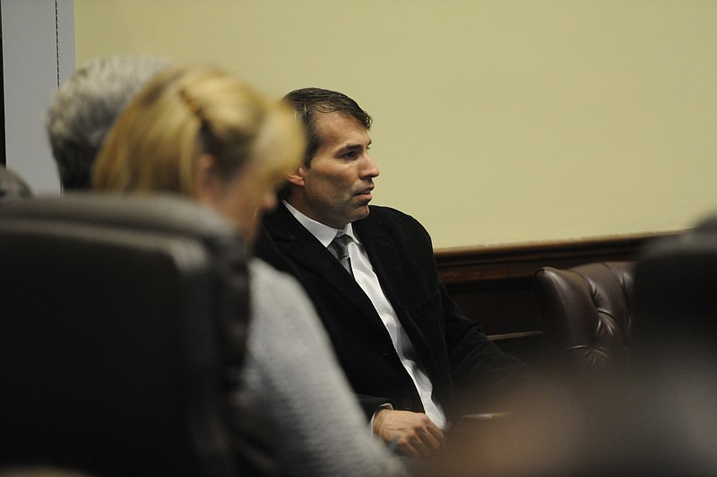 Club Fathom owner Tim Reid listens as city attorney Phil Noblett<cq> announces a temporary restraining order which would prevent any events other than church services from being held at the location on 412 Market St.