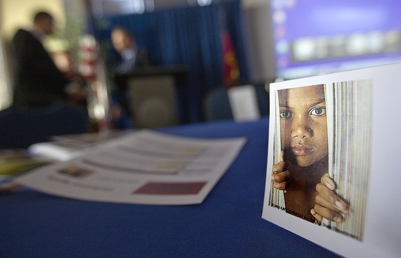 A placard of a child sits on a table during a conference on human sex trafficking in Atlanta. 