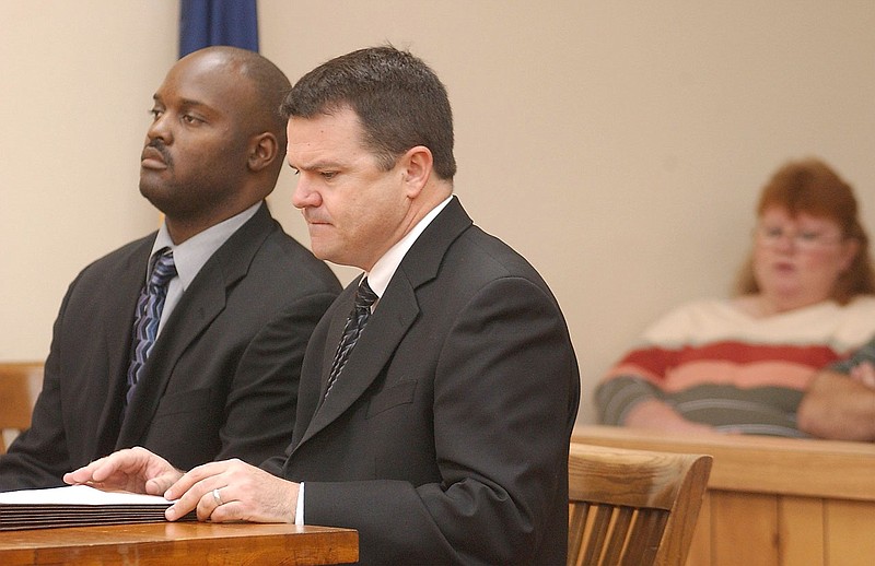 Former crematory operator Ray Brent Marsh, left, appeares in court for arraignment Tuesday, Sept. 23, 2003, in LaFayette, Ga., with his attorney Ken Poston. Lisa Cash, far right, watches the proceedings from the gallery. Marsh pleaded not guilty to 122 counts of burial service fraud and 47 counts of making false statements. Marsh, accused of dumping decaying bodies around his family business, faces multiple counts of burial service fraud, making false statements, abuse of a dead body and theft. He remains free on bond. 
Staff File Photo