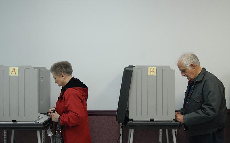 Freida McClure, left, and Fred Linkous vote at the Bradley County Election Commission in this file photo.