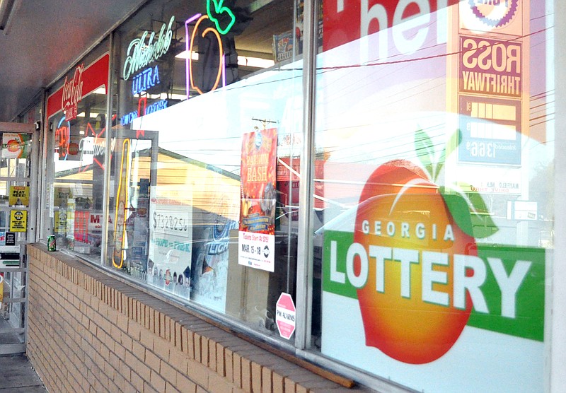 A Georgia Lottery sign hangs on the front window at Ross Thriftway on Wednesday afternoon at the store on LaFayette Road in Rossville.
