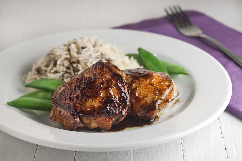 Combining several liquid items in a bowl to marinate some chicken thighs can result in a delightful chicken dinner.