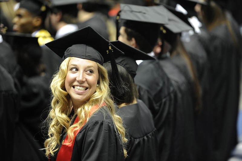 After the presentation of graduates and conferring of degrees, a University of Tennessee at Chattanooga student looks back at her loved ones during commencement inside of McKenzie Arena.