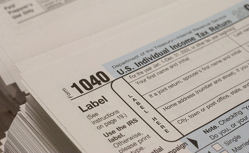 A stack of 1040 Income Tax forms sit on display in this file photo.