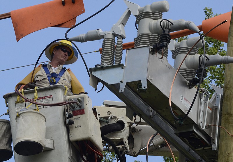 EPB worker David Handley installs the last Intelliruptor, a device that reroutes electric power to prevent outages, on utility poles along Patton Edwards Drive in East Ridge on Tuesday.