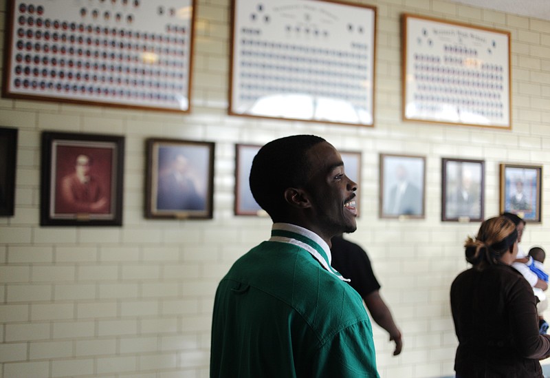 Jumoke Johnson smiles and laughs with a friend while heading for a student assembly at Brainerd High School.