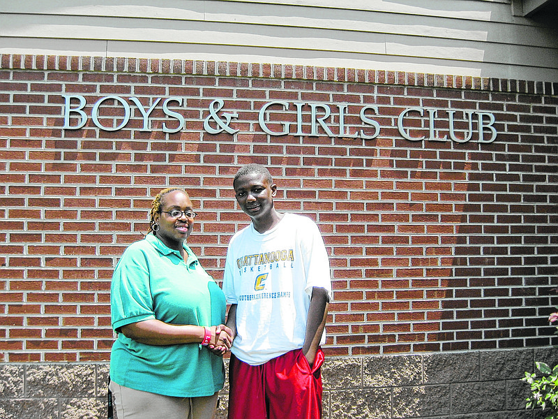 In this 2012 photo, Boys and Girls Club of Chattanooga unit manager Tahme'Sha Washington, left, congratulates Boys and Girls Club June 2012 Leader of the Month Anthony Edwards.