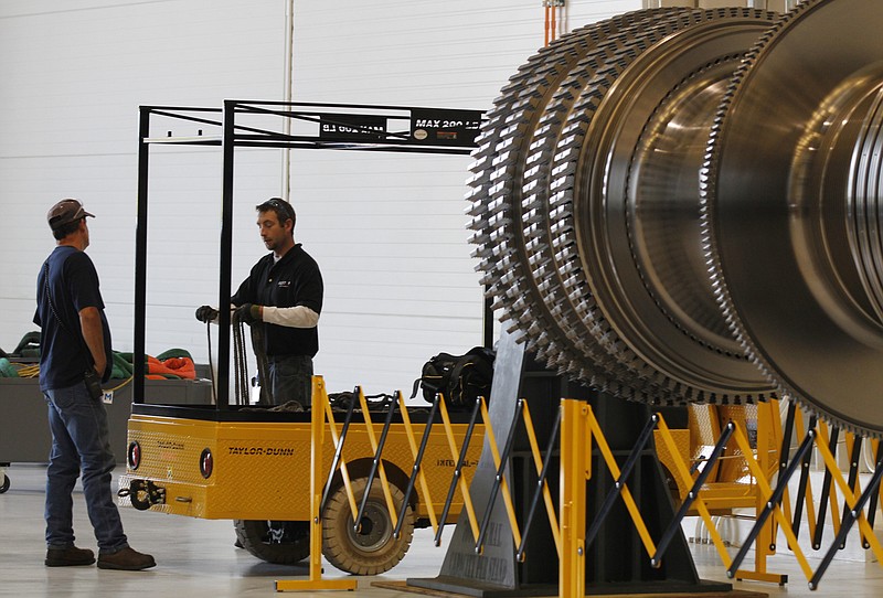 Employees work inside the Alstom Power Turbines factory on Riverfront Parkway.