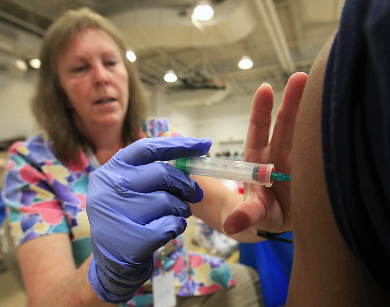 Nurse Susan Peel gives a whooping cough vaccination to a student at Inderkum High School, Monday, Sept. 19, 2011, in Sacramento, Calif. The whooping cough vaccine given to babies and toddlers loses much of its effectiveness after just three years _ a lot faster than doctors believed _ and that could help explain a recent series of outbreaks in the U.S. among children who were fully vaccinated, a study suggests. (AP Photo/Rich Pedroncelli)