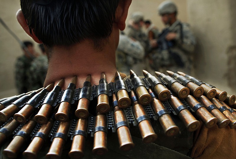An Afghan National Army soldier wears an ammunition belt around his neck during a joint patrol with United States Army soldiers from Bravo Company, 2nd Battalion of the 508 Parachute Infantry Regiment of the 82nd Airborne, in the volatile Arghandab Valley, outside Kandahar City.