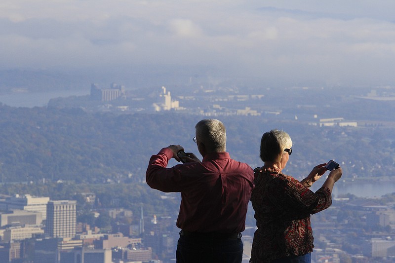 Patricia and David Dorion, visiting from Louisiana, take photos of Chattanooga's cityscape from Point Park atop Lookout Mountain.