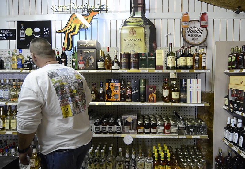 Stephen Waldron checks the shelves Wednesday at Hillbilly's Liquor in Dunlap, Tenn. Voters in Tennessee and North Georgia have relaxed their attitudes about legal alcohol sales in recent years, adopting package sales and liquor by the drink in restaurants and bars.