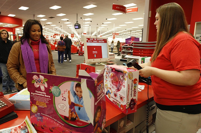 Sheathia Lee, left, returns gifts for her two children to guest service employee Bailey Roy while at the Target off Gunbarrel Road on Wednesday.