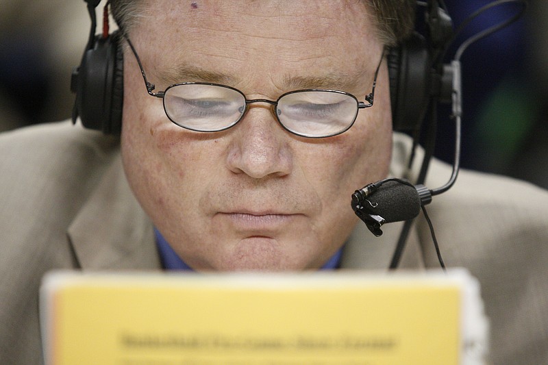 Jim Reynolds, known as the "Voice of the Mocs," looks at a roster in 2013 before announcing his 1,000th University of Tennessee at Chattanooga basketball game on the radio.