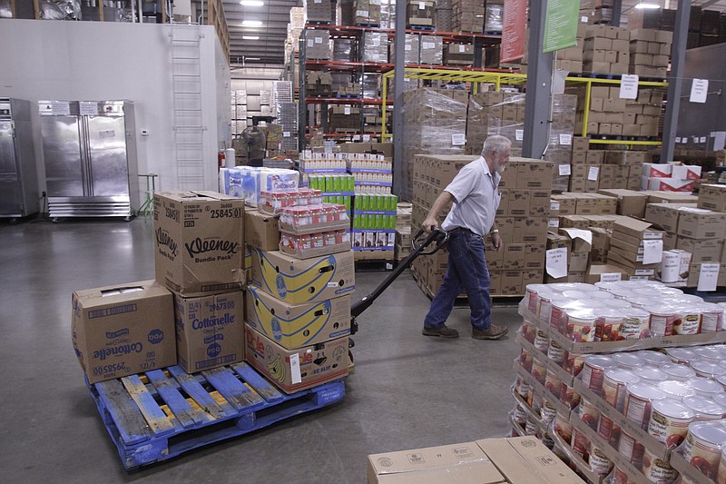 Jim Massingale hauls a pallet of food items at the Chattanooga Area Food Bank in this file photo.