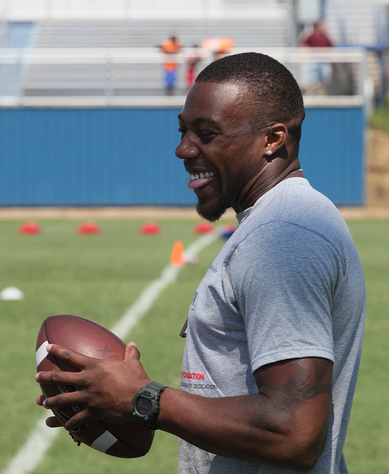 Eric Berry laughs with camp participants Friday afternoon during his football camp at Boyd-Buchanan School.