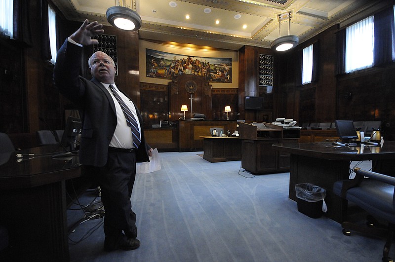 U.S. District Court Chief Deputy Clerk John Medearis looks to the ceiling of the third floor courtroom where there was previous water damage inside the Joel W. Solomon Federal Building.
