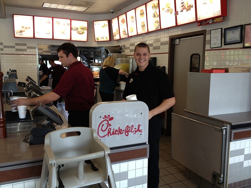 From left, employees Adam Enoch, Victoria Kirstein and Greg Fugunt prepare meals at the Highway 153 Chick-fil-a.