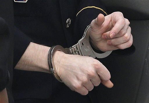 Army Pfc. Bradley Manning wears handcuffs as he is escorted into a courthouse in Fort Meade, Md., Wednesday, Aug. 21, 2013, before a sentencing hearing in his court martial. Manning was sentenced Wednesday to 35 years in prison for giving hundreds of thousands of secret military and diplomatic documents to WikiLeaks.