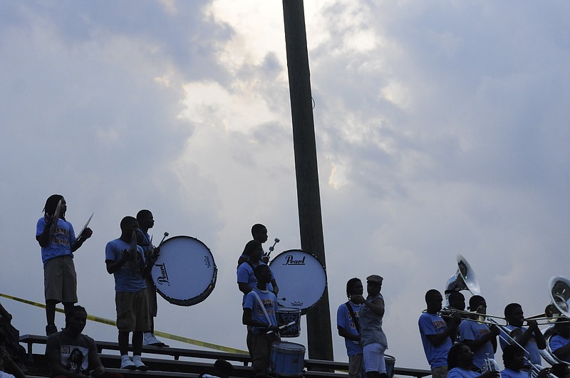 The Brainerd High Marching Band plays as a lightning delay is called during a game in 2013.