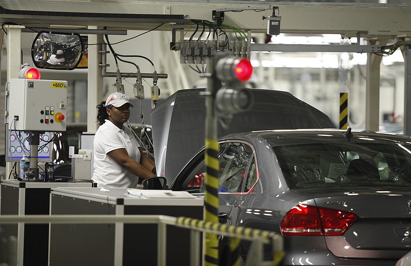 A factory worker performs diagnostics on a Passat before it is taken through a dyanometer in the assembly section of the Chattanooga Volkswagen Plant in Chattanooga, Tenn. Volkswagen's Chattanooga manufacturing plant has implemented energy management and environmentally friendly procedures which will be used in other Volkswagen plants across the globe.