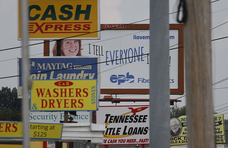 A motorist passes numerous loan service businesses off Ringgold Road in East Ridge on Monday. Chattanooga has a high number of payday lenders.