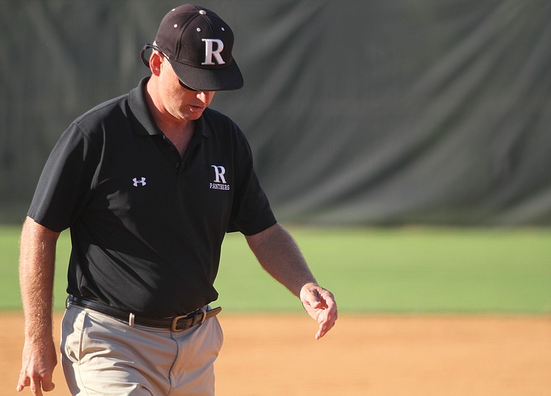 Ridgeland coach Richie Wood walks back to the dugout after a timeout from a softball game at Ridgeland High School in Rossville, Ga.