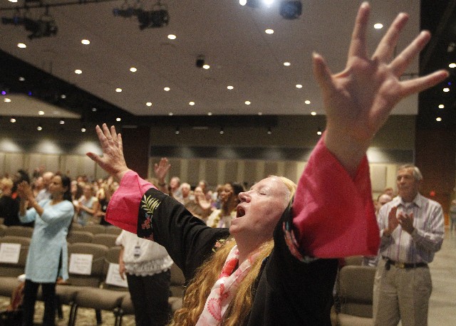 Eleanor Wilson sings along during a worship service at evangelist Perry Stone's annual conference, called "The Main Event," at the Omega Center International in Cleveland, Tenn., on Thursday, Oct. 10, 2013.