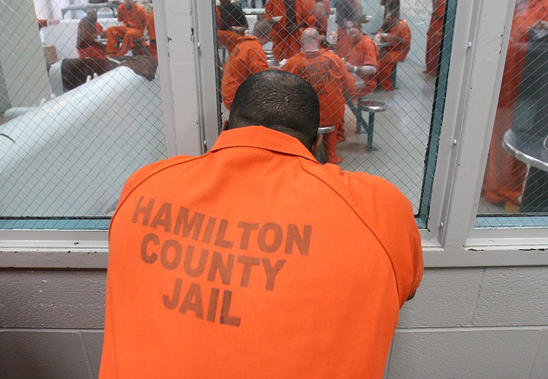 An unidentified Hamilton County inmate waits to be re-admitted to his holding cell on the second floor of the Hamilton County Jail.