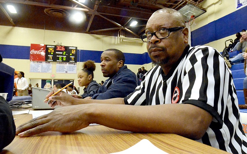 Official scorekeeper Darrell Dallas, right, works during a basketball game at the recent Best of Preps tournament at the Chattanooga State gym, working alongside clock keeper Keitha Booker.