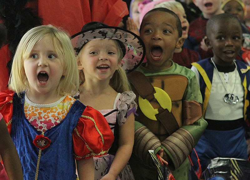 From left to right, Chloe McKee, Alauna Vaughn and Major Gilbert yell "Trick or Treat" at the TVA office complex where children from the Chambliss Center for Children trick-or-treated in Chattanooga.